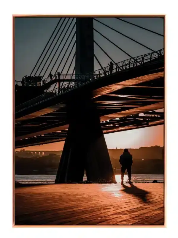 Silhouetted Figure Under Bridge