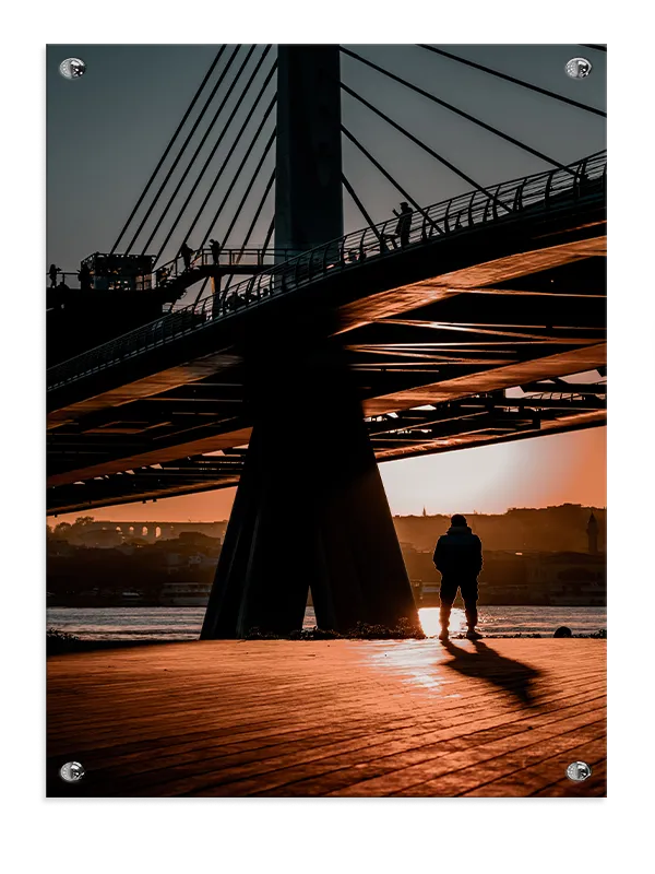Silhouetted Figure Under Bridge