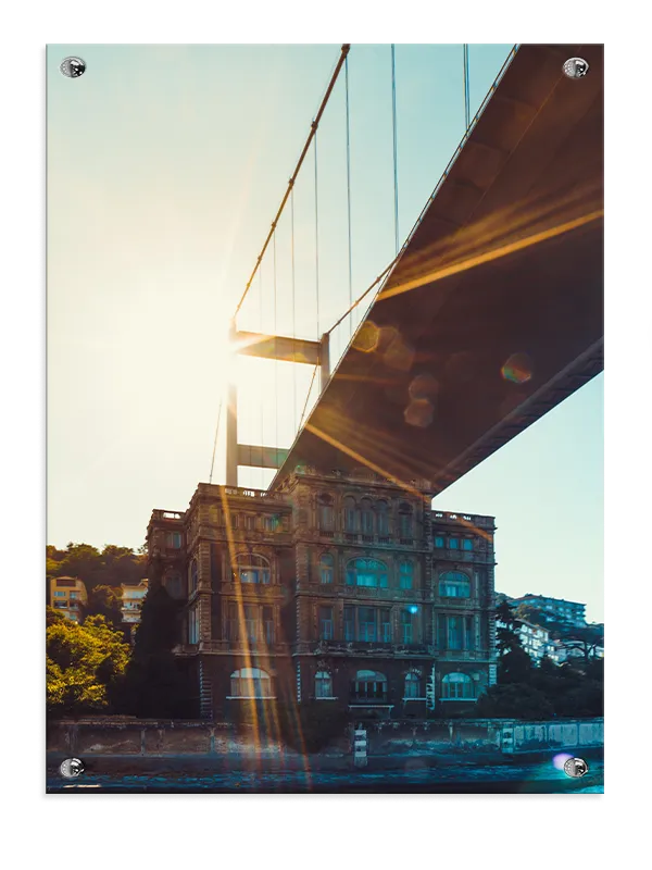 Sunlit Bridge Over Historic Building